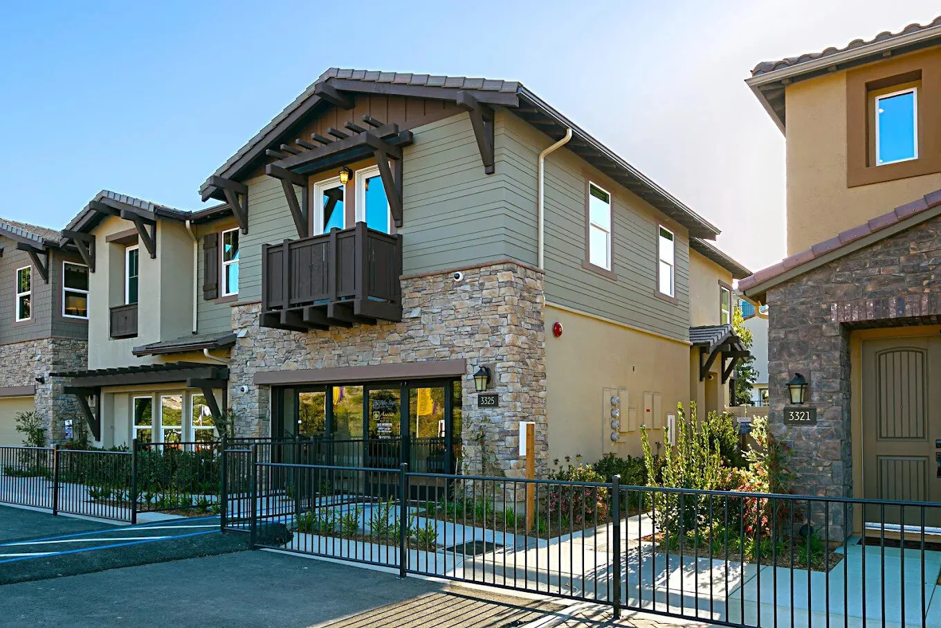 Bluesage two-story townhomes behind a black iron fence